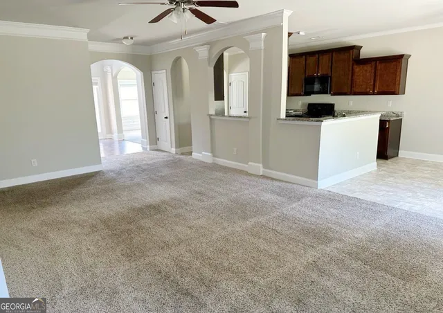 a view of a hallway with a window and a bathroom