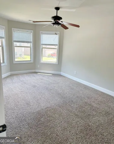 a view of an empty room and a window