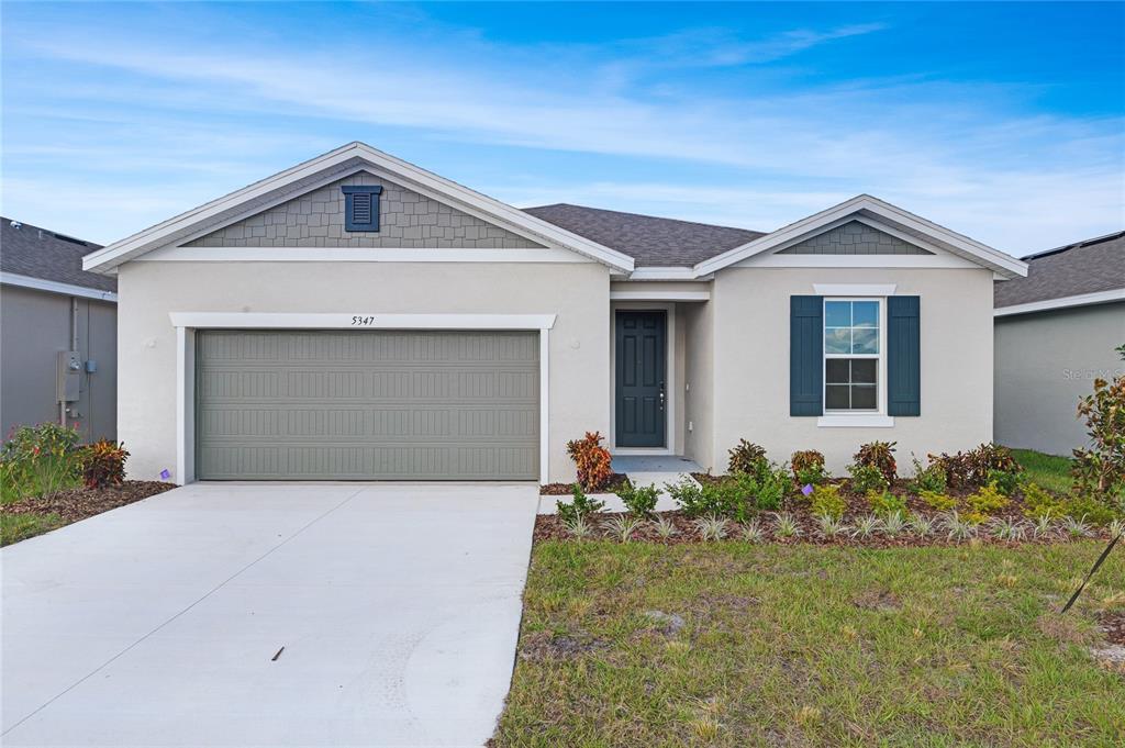 5347 Mickey Avenue Lake Wales, FL 33859 - Photo 2 of 18 a front view of a house with garden