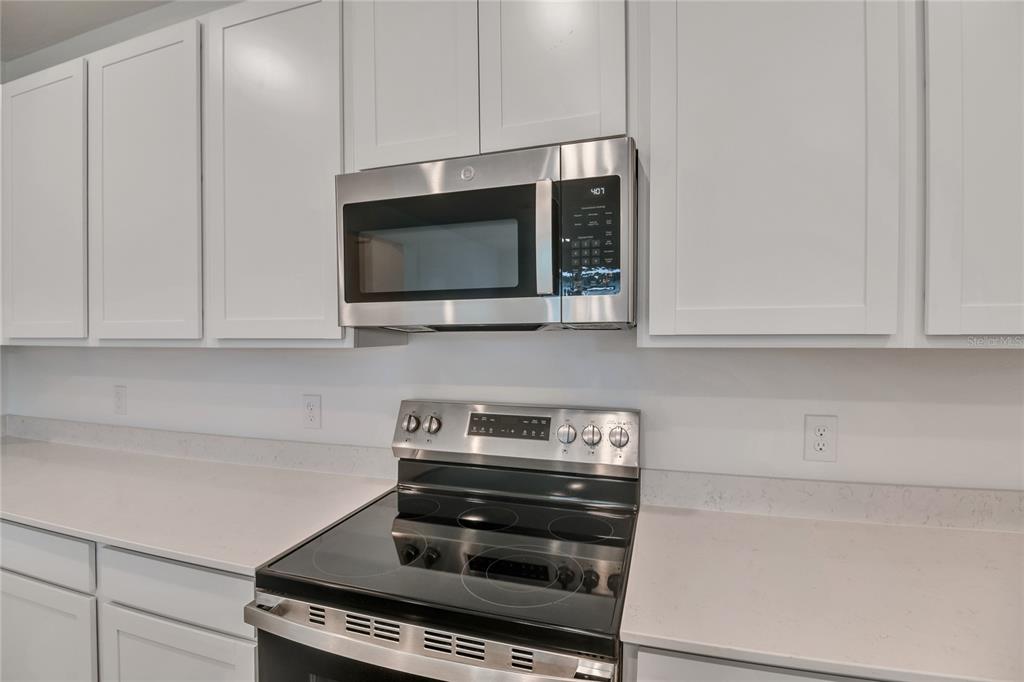 5347 Mickey Avenue Lake Wales, FL 33859 - Photo 7 of 18 a kitchen with a stove and a microwave