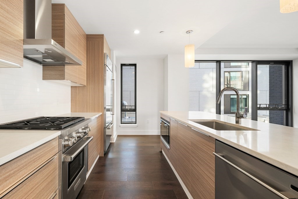 a kitchen with a sink stove and cabinets