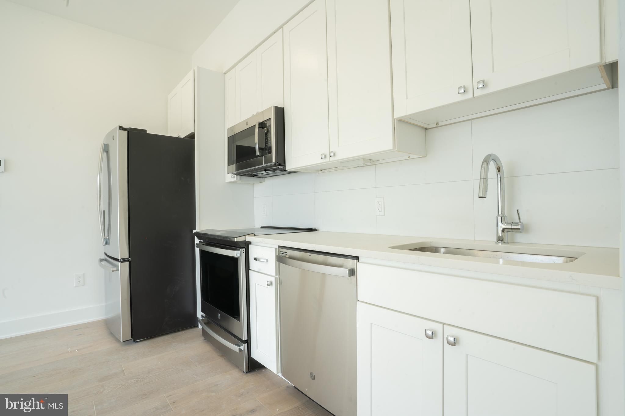5301 Connecticut Avenue Northwest, Unit 403 Washington, DC 20015 - Photo 2 of 12 a kitchen with stainless steel appliances granite countertop white cabinets and a sink