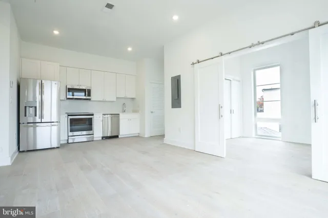 a view of a kitchen with a sink and a refrigerator