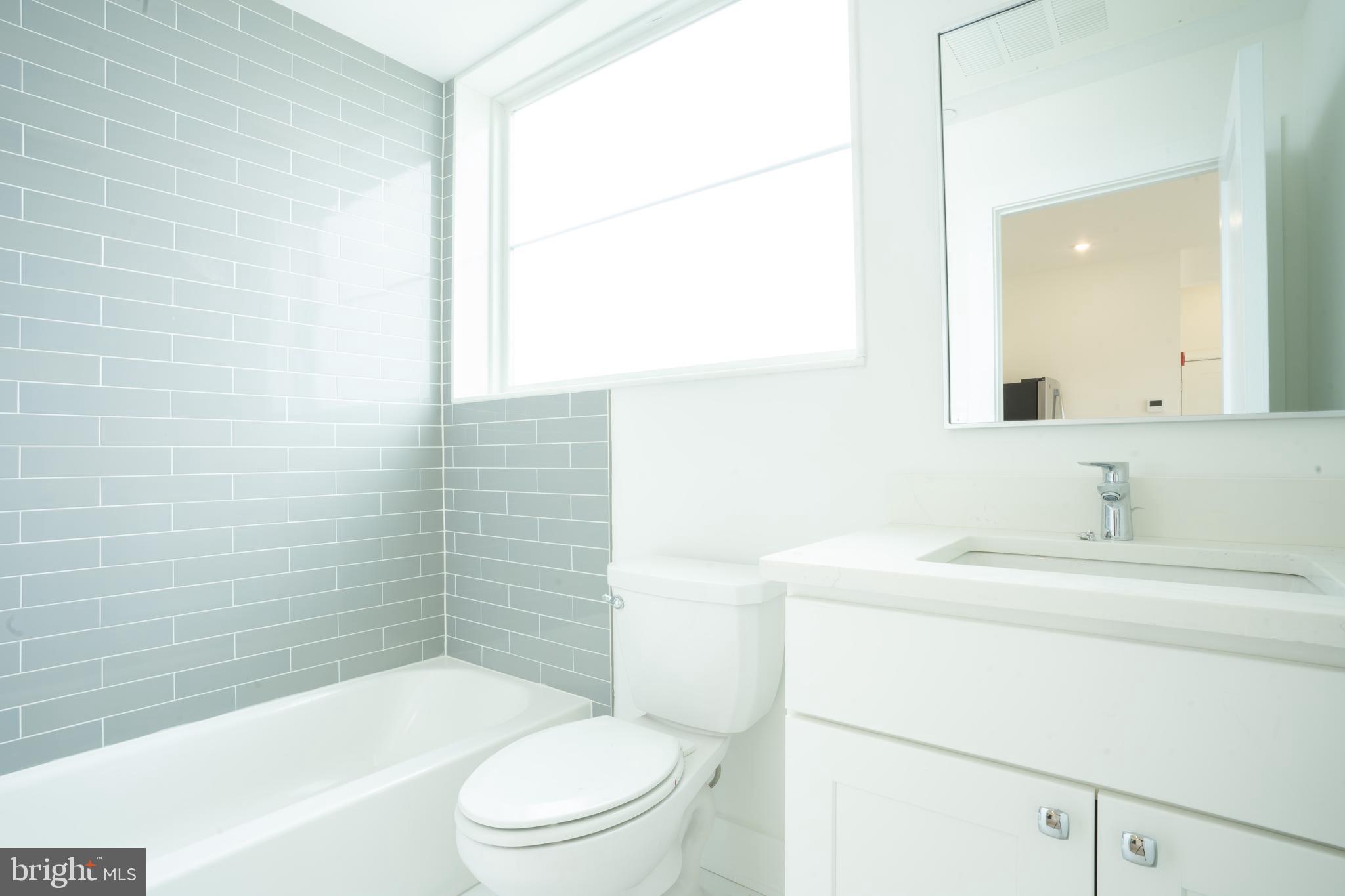 5301 Connecticut Avenue Northwest, Unit 403 Washington, DC 20015 - Photo 9 of 12 a bathroom with a sink a toilet and shower