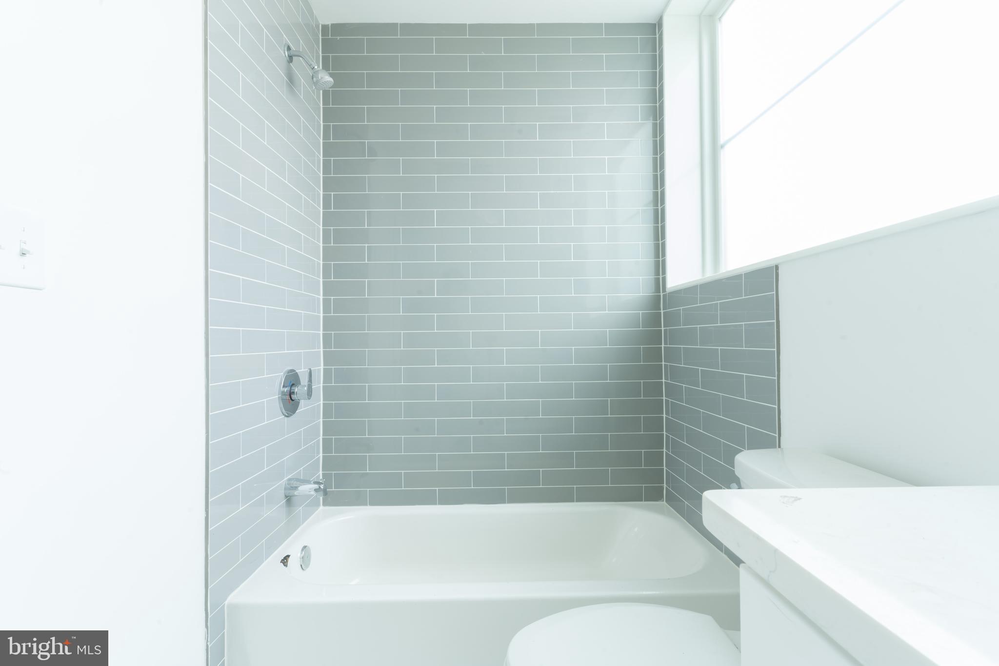 5301 Connecticut Avenue Northwest, Unit 403 Washington, DC 20015 - Photo 10 of 12 a bathroom with a bathtub and shower