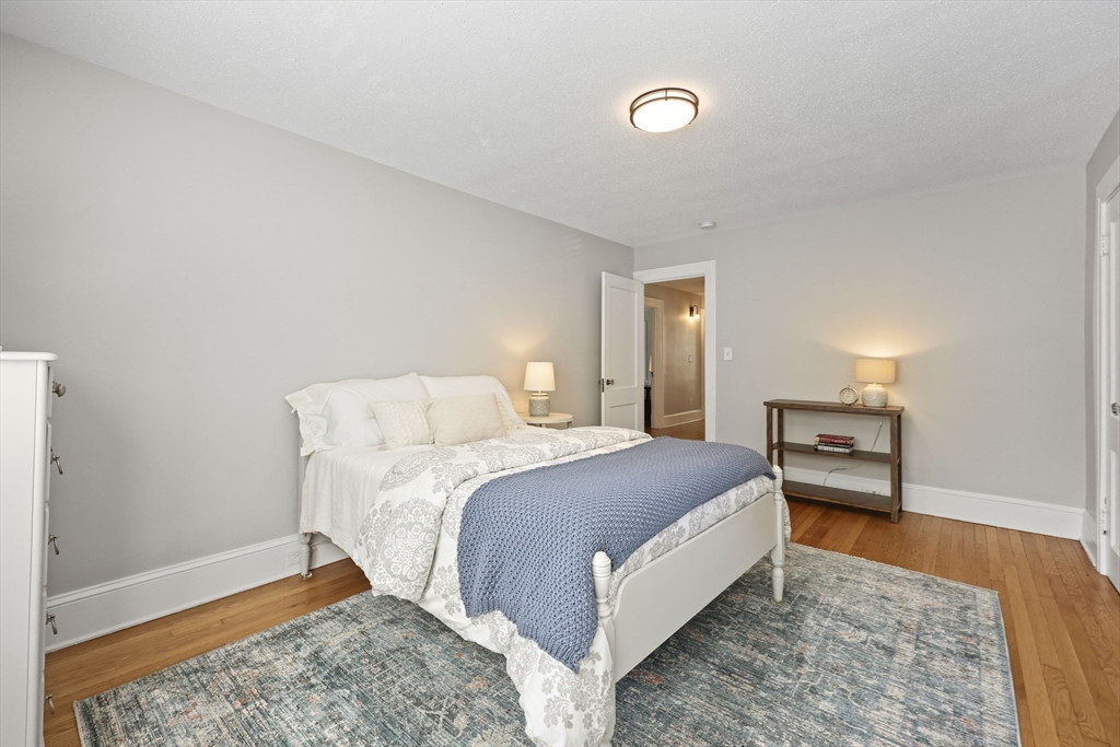 77 Longmeadow Street Longmeadow, MA 01106 - Photo 20 of 41 a bedroom with a bed and wooden floor