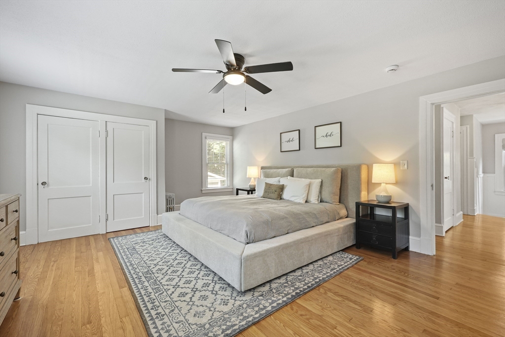 77 Longmeadow Street Longmeadow, MA 01106 - Photo 23 of 41 a spacious bedroom with a bed and wooden floor