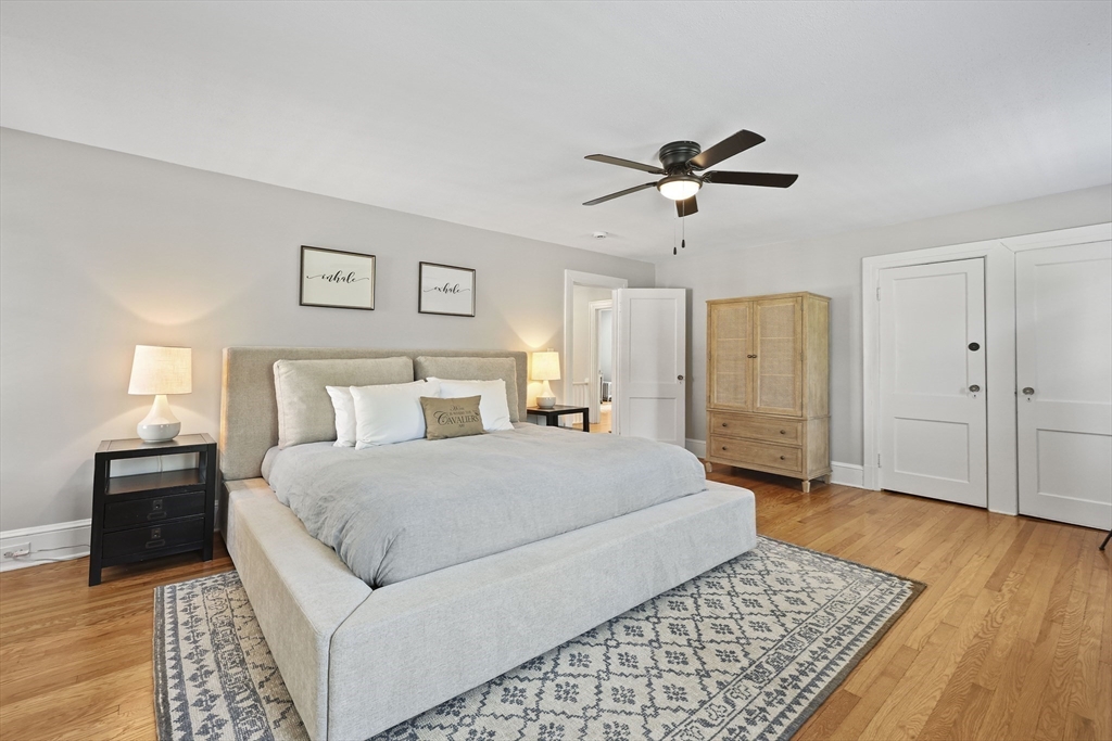 77 Longmeadow Street Longmeadow, MA 01106 - Photo 25 of 41 a spacious bedroom with a bed and a chandelier