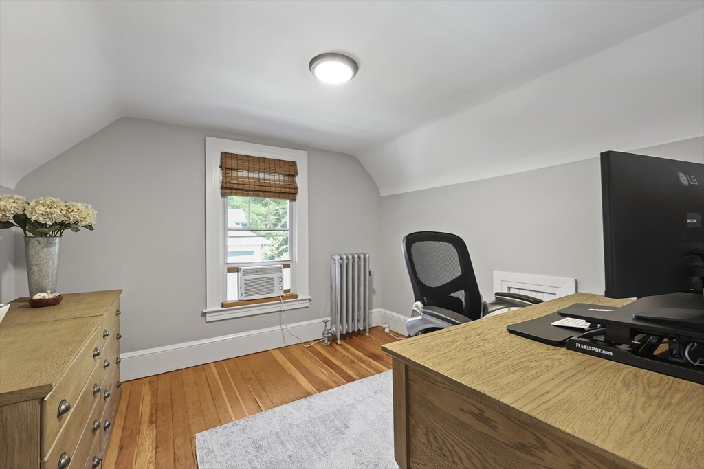 77 Longmeadow Street Longmeadow, MA 01106 - Photo 30 of 41 a bedroom with a bed and a flat tv screen on the dresser