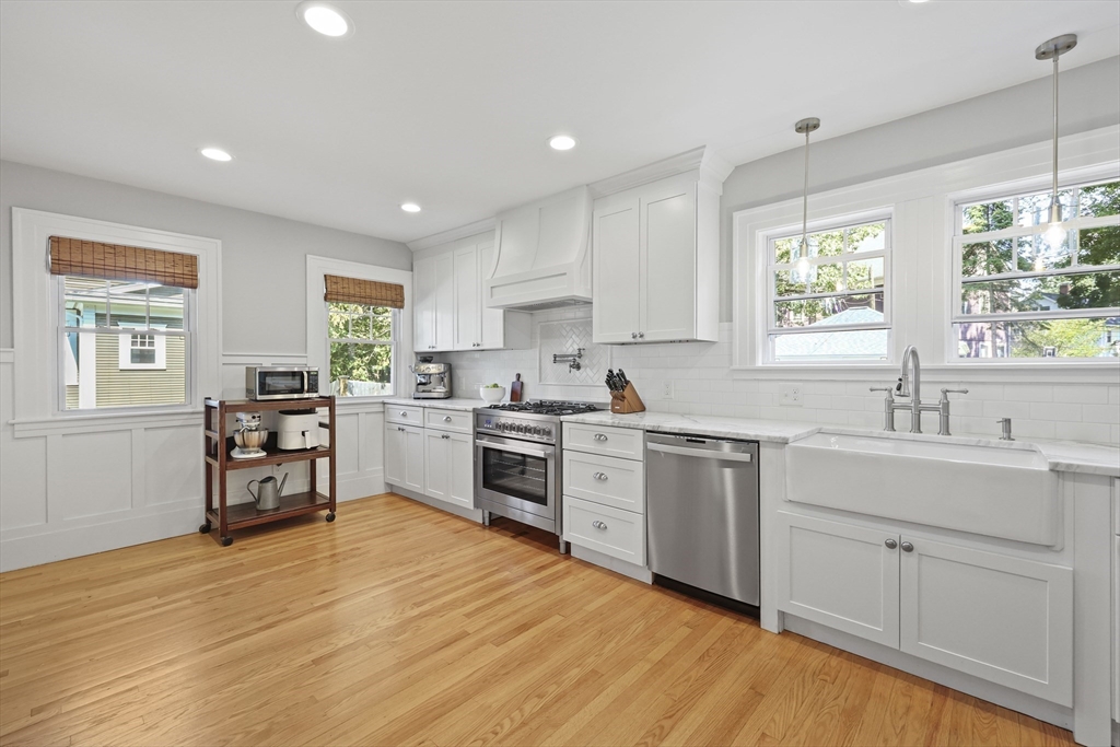 77 Longmeadow Street Longmeadow, MA 01106 - Photo 8 of 41 a kitchen with a sink window and cabinets