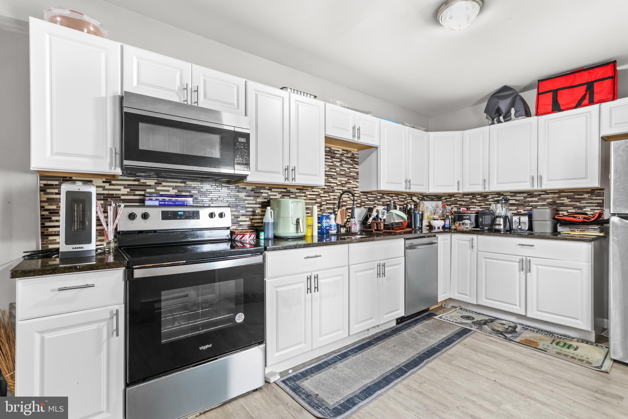 12 South Front Street Coplay, PA 18037 - Photo 10 of 42 a kitchen with stainless steel appliances granite countertop a stove microwave and cabinets