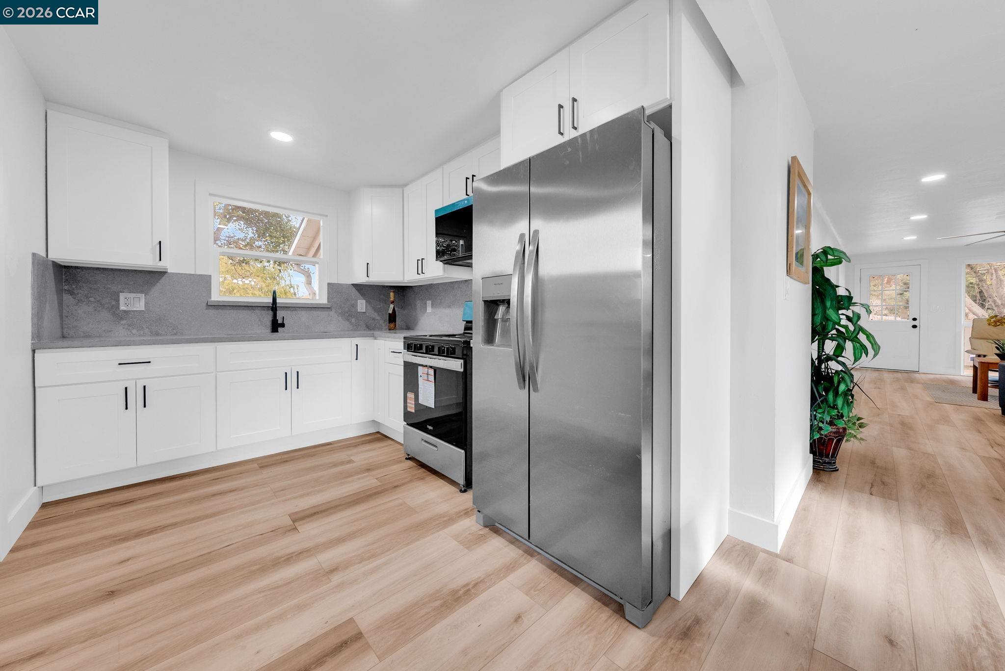 2699 Vale Road San Pablo, CA 94806 - Photo 9 of 30 a kitchen with stainless steel appliances a refrigerator sink and cabinets