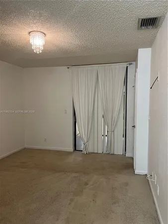 an empty room with a window and a fireplace