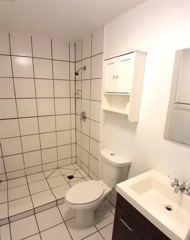 a bathroom with a toilet a sink and a mirror