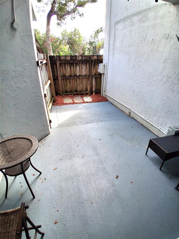 2718 South University Drive, Unit 17B Fort Lauderdale, FL 33328 - Photo 18 of 28 a view of a backyard with wooden fence