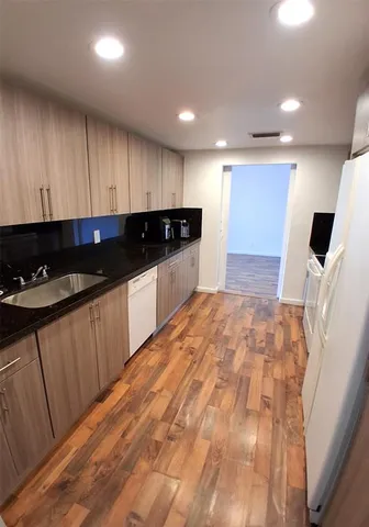 a kitchen with stainless steel appliances a refrigerator sink and cabinets