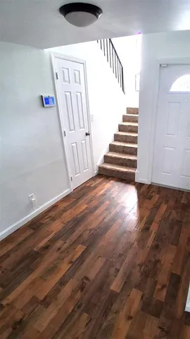 a view of entryway with stairs and wooden floor