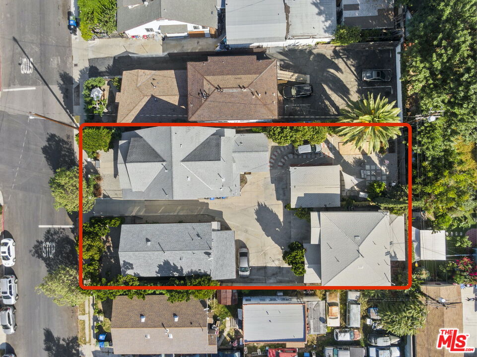 an aerial view of residential houses and car parked