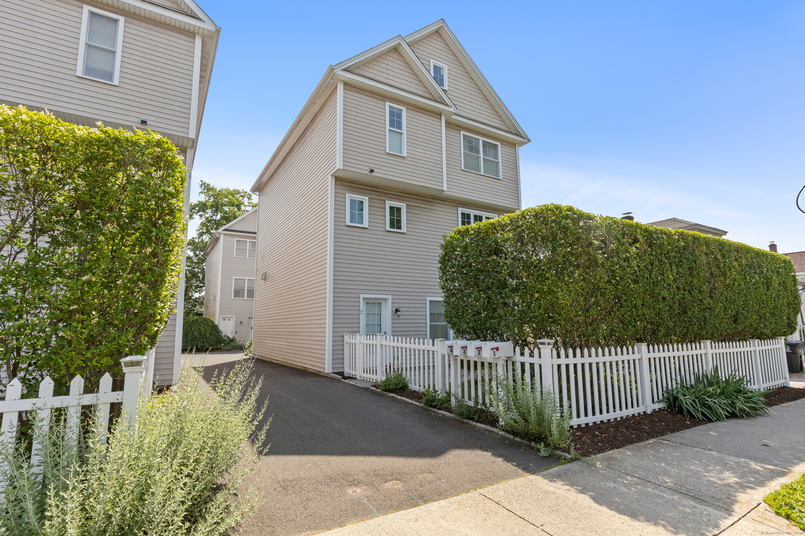 a front view of a house with a garden