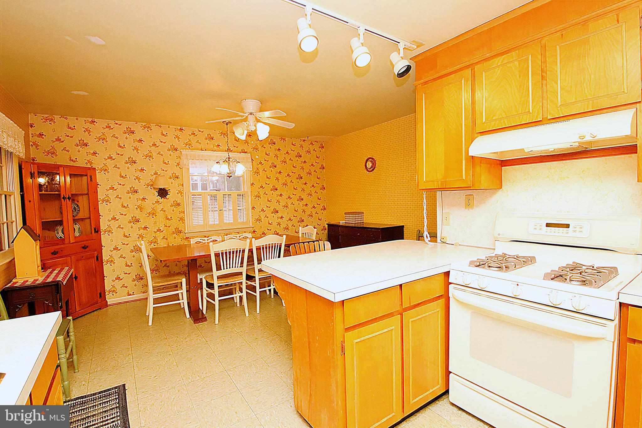 414 Beaver Creek Road Hagerstown, MD 21740 - Photo 12 of 33 a kitchen that has a stove and a table
