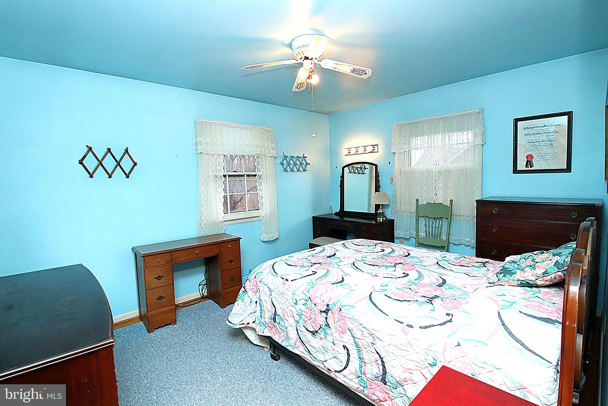 414 Beaver Creek Road Hagerstown, MD 21740 - Photo 15 of 33 a bedroom that has a bed and a chair in it