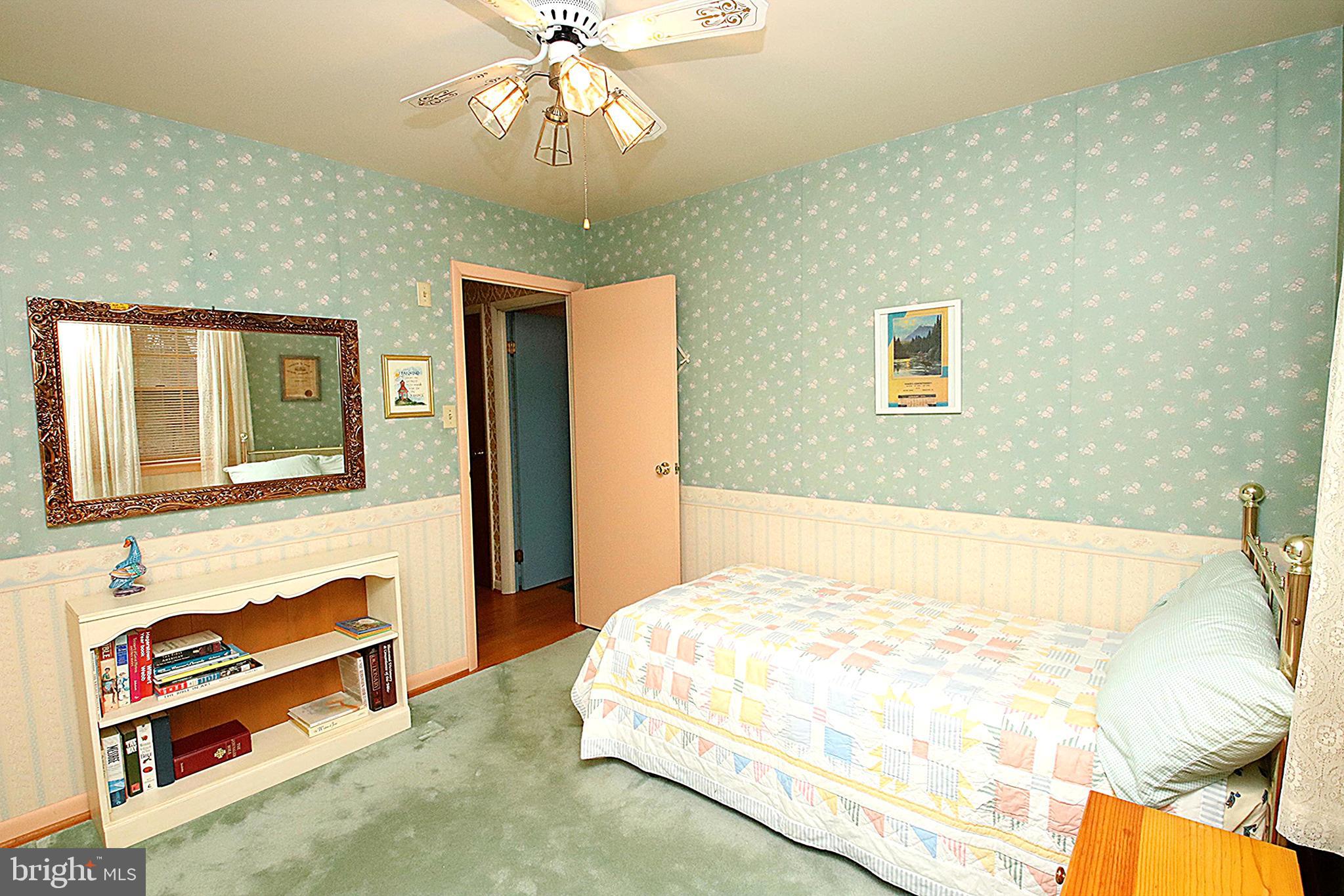 414 Beaver Creek Road Hagerstown, MD 21740 - Photo 20 of 33 a bedroom with a bed and a chandelier