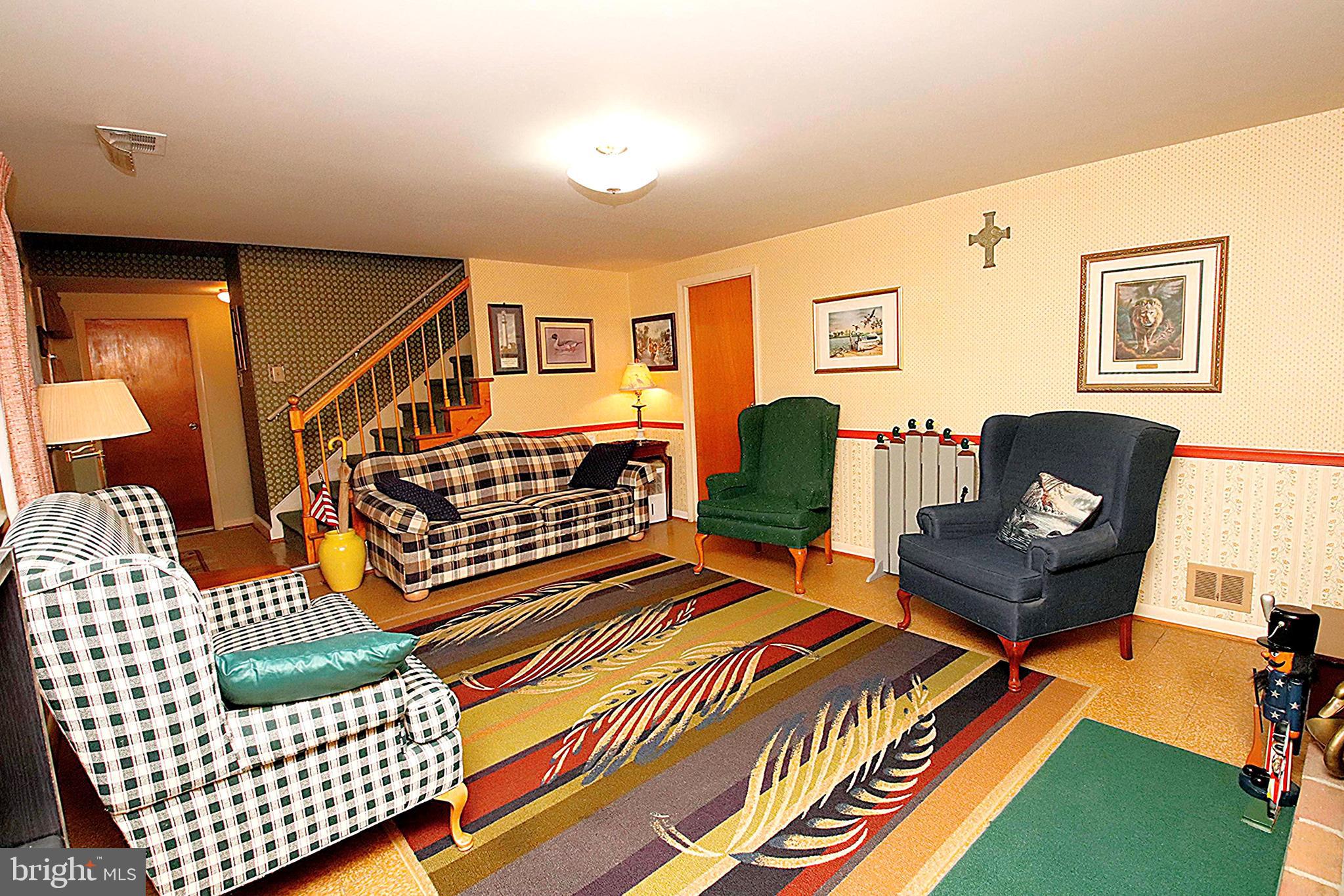 414 Beaver Creek Road Hagerstown, MD 21740 - Photo 24 of 33 a living room with a couch and dresser with wooden floor