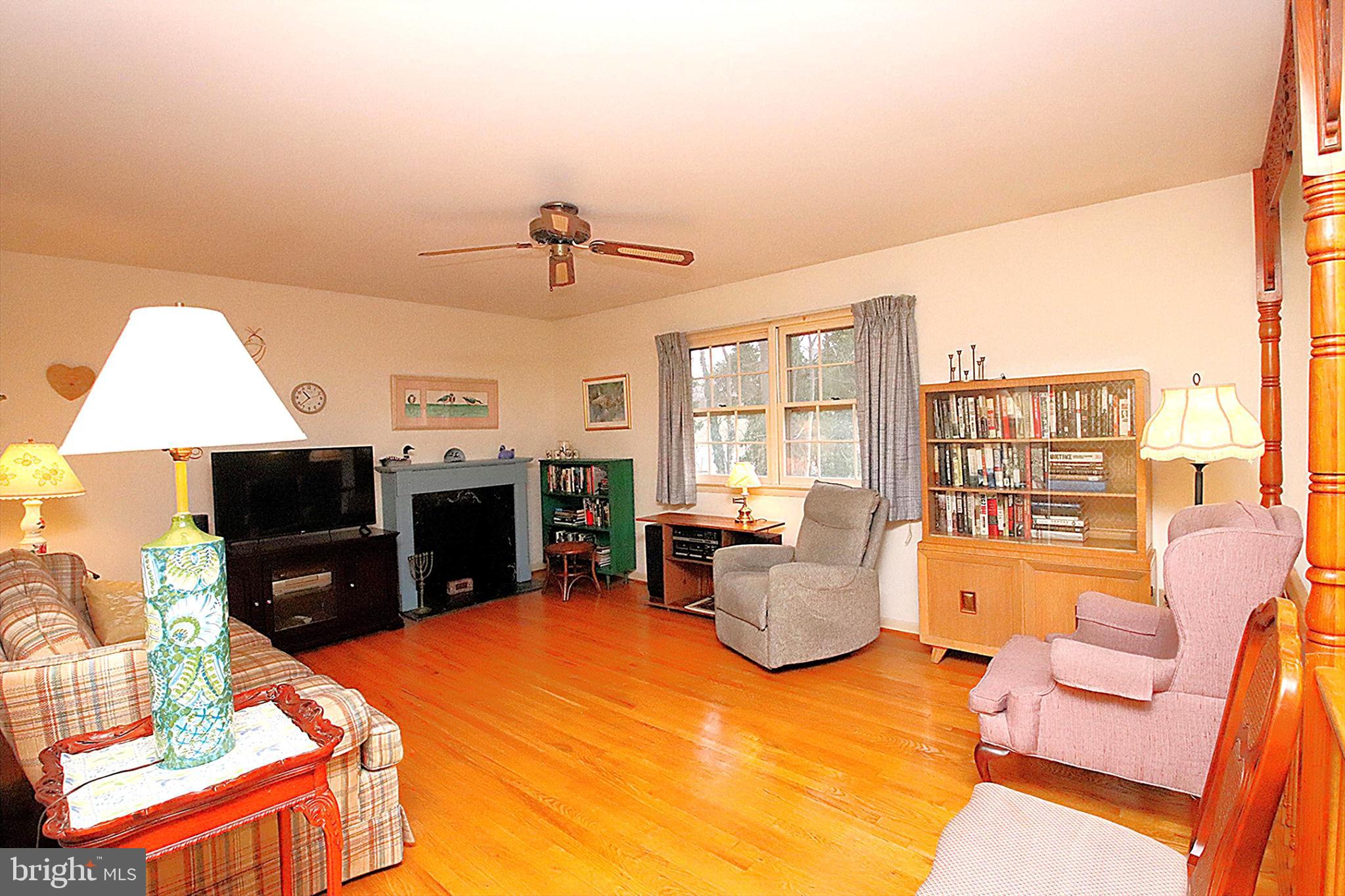 414 Beaver Creek Road Hagerstown, MD 21740 - Photo 5 of 33 a living room with furniture a fireplace and a flat screen tv