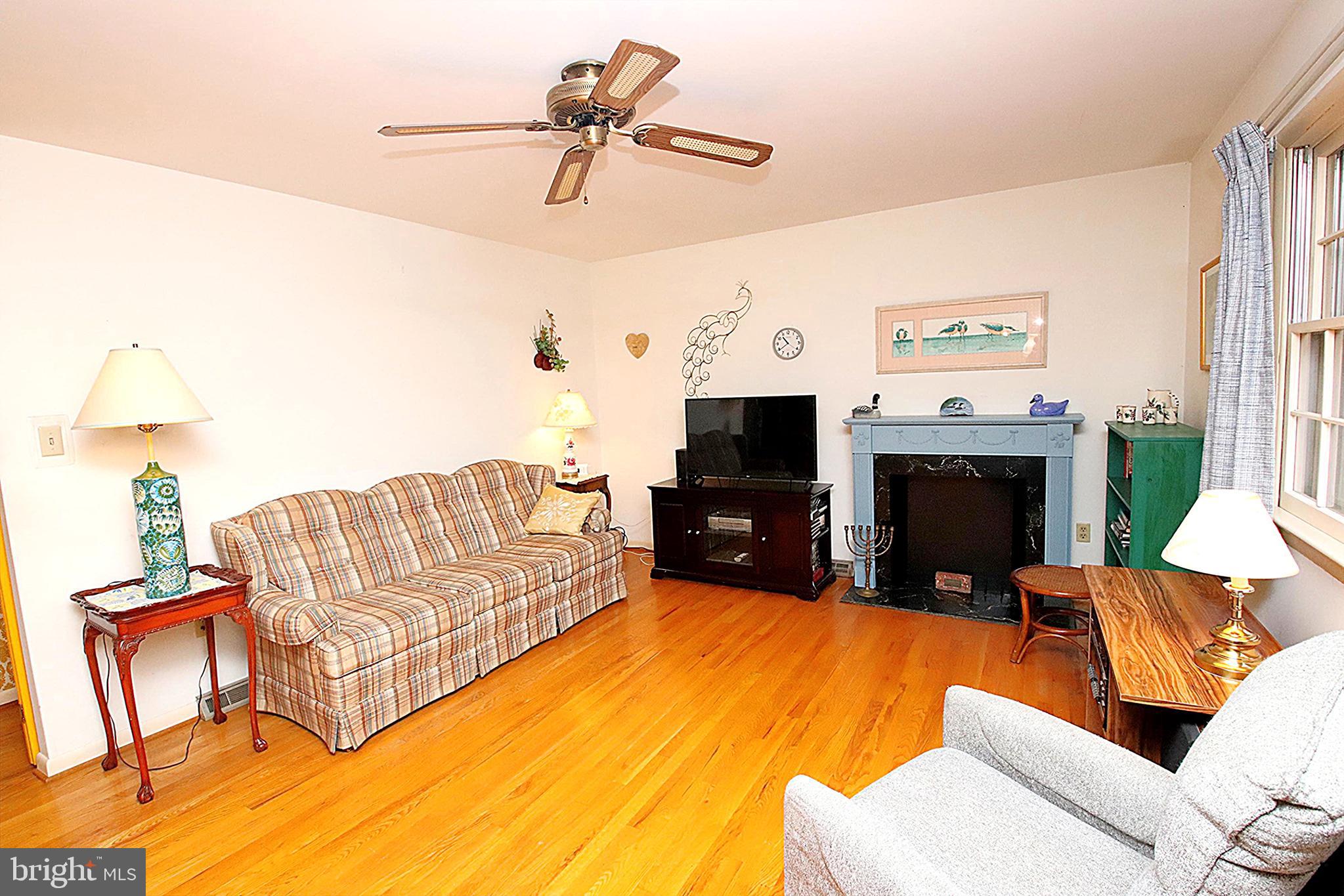 414 Beaver Creek Road Hagerstown, MD 21740 - Photo 7 of 33 a living room with furniture a fireplace and a flat screen tv