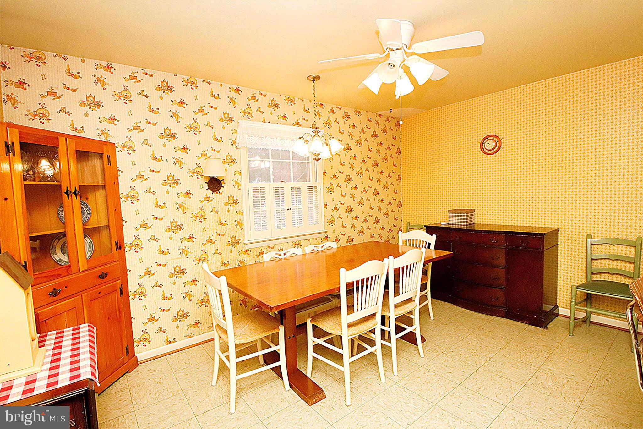 414 Beaver Creek Road Hagerstown, MD 21740 - Photo 10 of 33 a dining room with chandelier fan and wooden floor