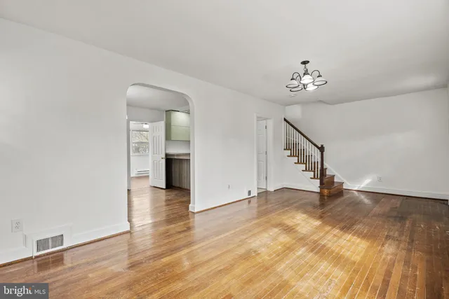 a view of an empty room with a window and fireplace