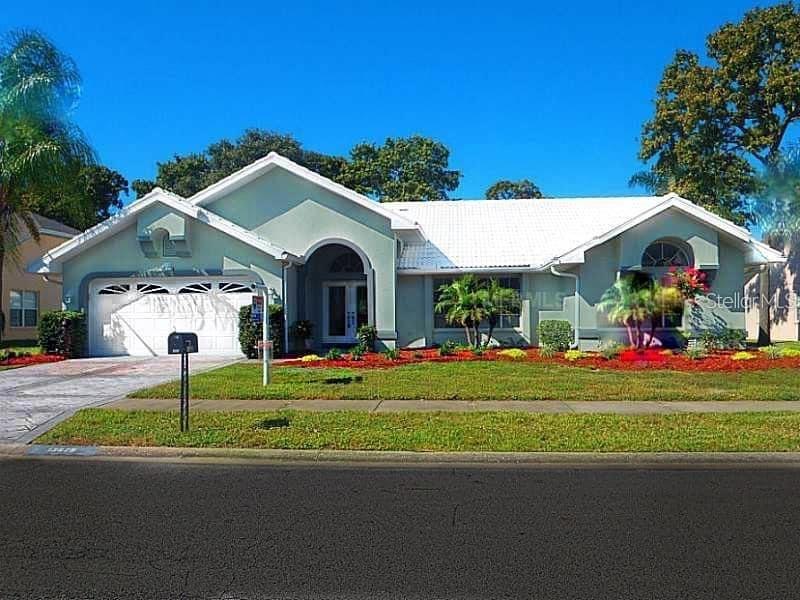 a front view of a house with a yard and garage