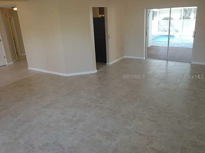 13625 Deventer Court Hudson, FL 34667 - Photo 2 of 14 an empty room with sliding glass door