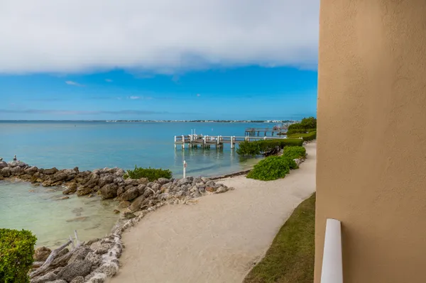 a kitchen with granite countertop a stove and white cabinets