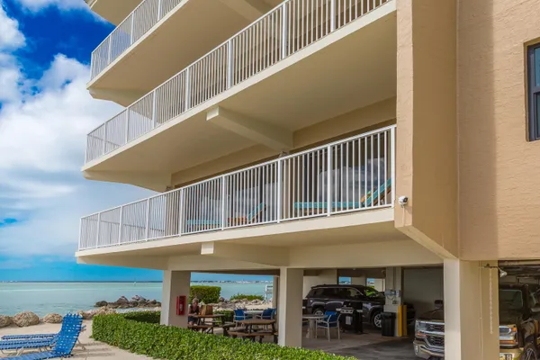 a large kitchen with stainless steel appliances a stove a sink a oven a dining table and chairs