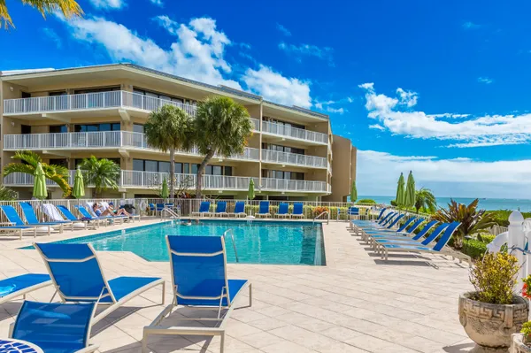 a kitchen with granite countertop white cabinets white stainless steel appliances with a sink and dishwasher