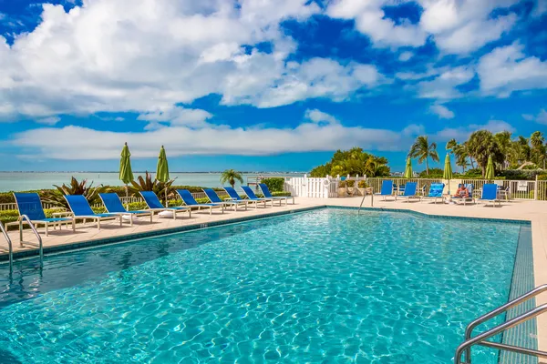a living room with furniture and floor to ceiling windows