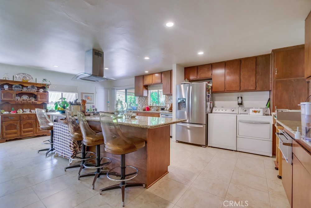 4329 Canyon Crest Road Altadena, CA 91001 - Photo 13 of 29 a kitchen with refrigerator and chairs