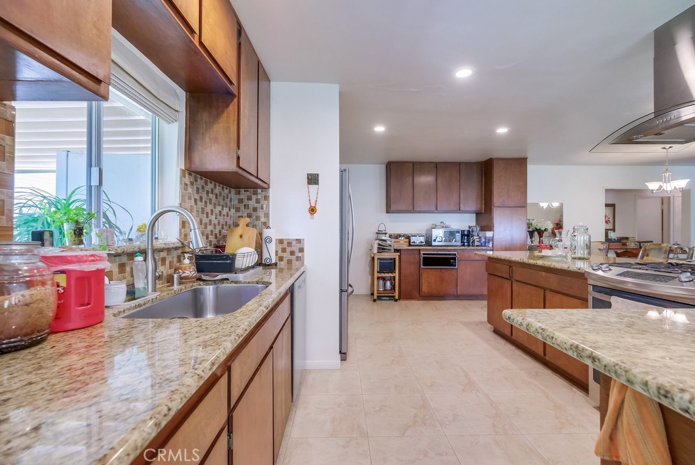 4329 Canyon Crest Road Altadena, CA 91001 - Photo 15 of 29 a kitchen with stainless steel appliances granite countertop sink stove and cabinets