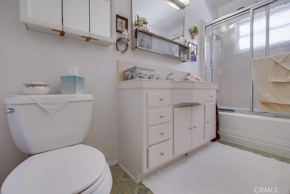 4329 Canyon Crest Road Altadena, CA 91001 - Photo 17 of 29 a bathroom with a granite countertop toilet sink and mirror