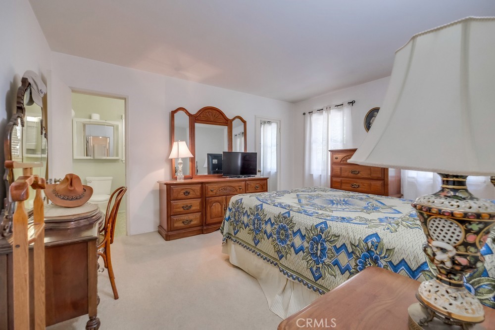 4329 Canyon Crest Road Altadena, CA 91001 - Photo 18 of 29 a bedroom with a bed and a dresser with mirror