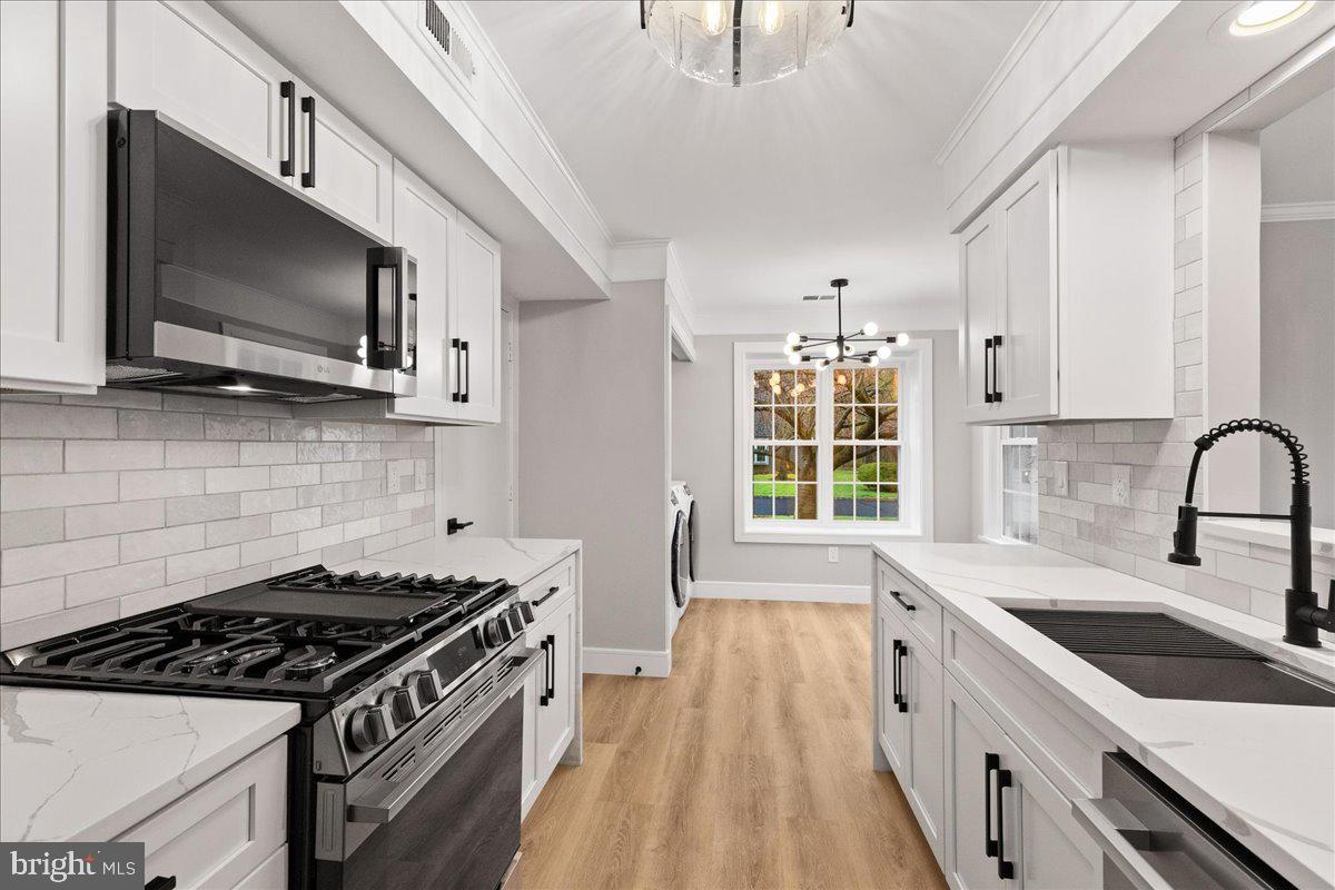 21 Andover Circle Princeton, NJ 08540 - Photo 13 of 31 a kitchen with stainless steel appliances granite countertop a sink stove and microwave