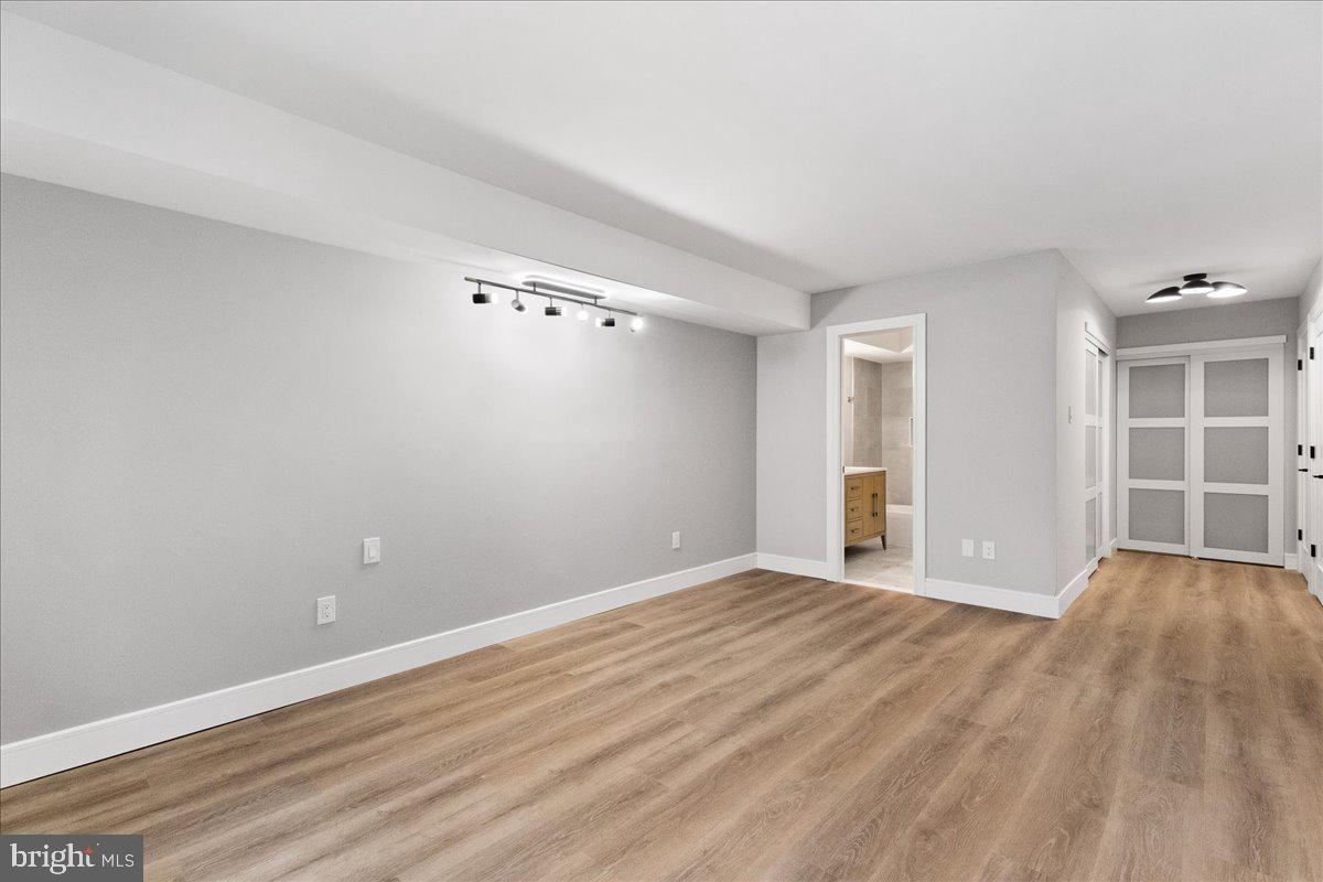 21 Andover Circle Princeton, NJ 08540 - Photo 16 of 31 a view of an empty room with wooden floor and kitchen