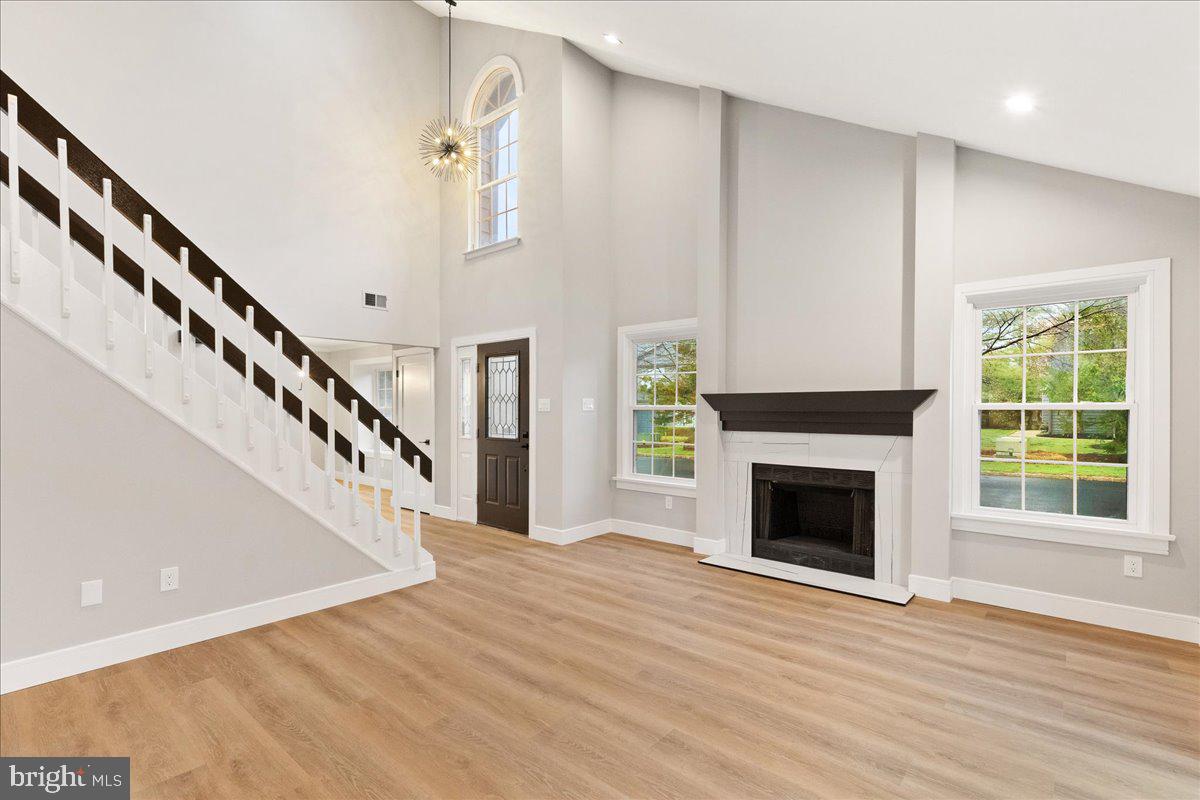 21 Andover Circle Princeton, NJ 08540 - Photo 5 of 31 a view of an empty room with wooden floor fireplace and a window
