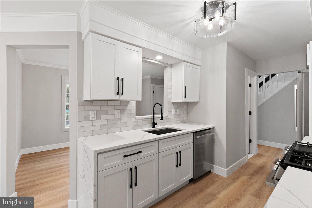 21 Andover Circle Princeton, NJ 08540 - Photo 10 of 31 a kitchen with a sink dishwasher a stove and white cabinets