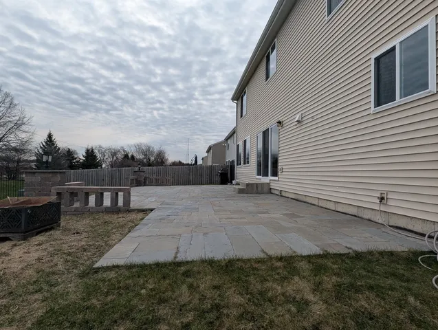a view of a house with backyard and sitting area