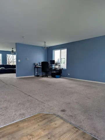 a view of a livingroom with furniture and a window