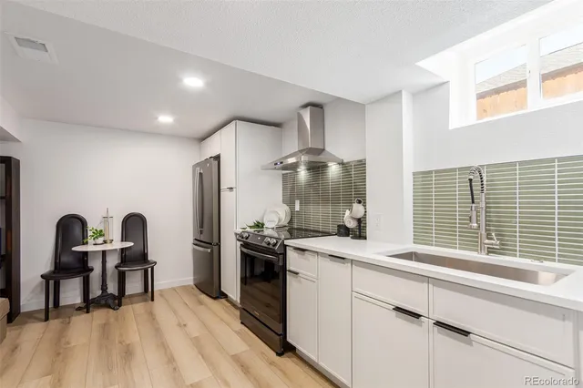 a kitchen with table and chairs