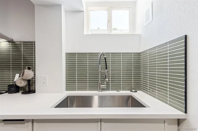 a kitchen with a sink and a window