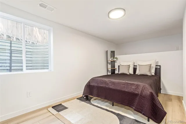 a bedroom with a bed and window